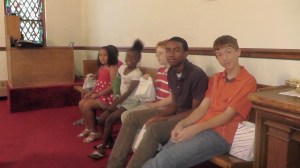 Children and youth wait before the service in preparation of honoring the congregation's fathers with decorated gift bags of muffins and hand made key chains.